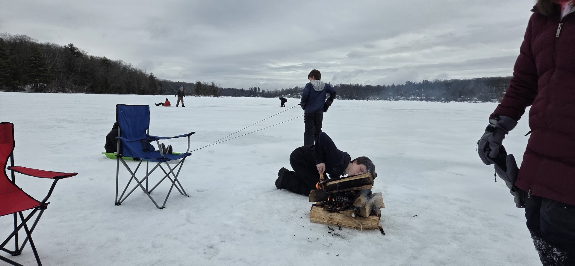 Scouts gathered on the frozen lake during the ice fishing trip.